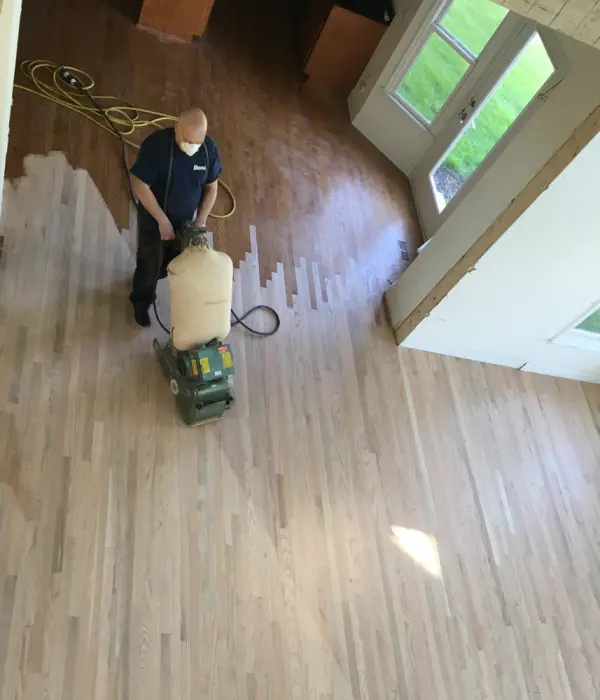 Hardwood floor drum sanding process – FLOORecki Floors & Stairs Hardwood floor sanding in progress using a drum sander by a FLOORecki technician in a Chicago home