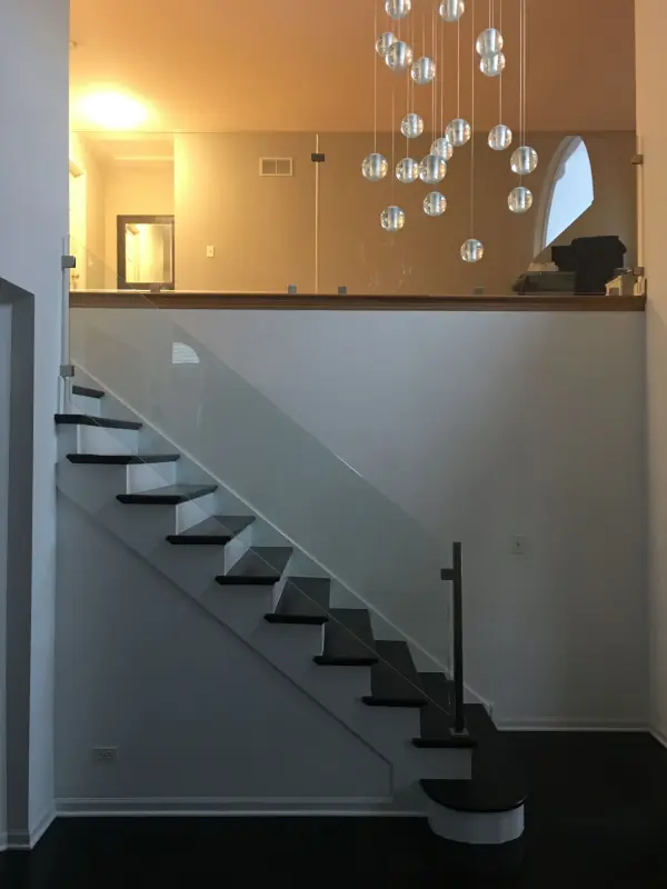 Custom staircase build with glass balusters – FLOORecki Floors & Stairs Custom staircase built by FLOORecki with glass balusters installed by a partner company in a Chicago home