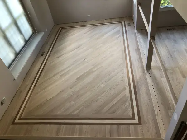 Red oak floor with maple and walnut border – FLOORecki Floors & Stairs Red oak hardwood floor installation with custom maple and walnut border in a Chicago area home