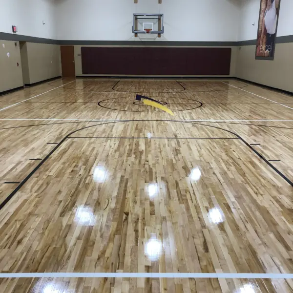 Commercial basketball court floor with painted logo LA Fitness Chicago — FLOORecki Floors & Stairs 
