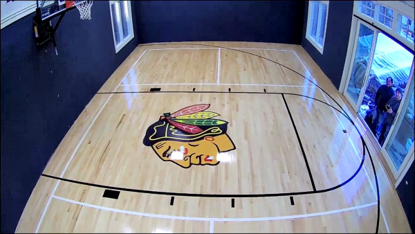 Private home basketball court flooring – FLOORecki Floors & Stairs Private home basketball court floor with painted game lines and custom center logo