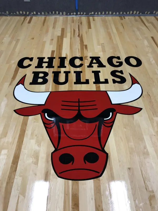Custom basketball court logo painting – FLOORecki Floors & Stairs Completed home basketball court Chicago Bulls maple hardwood floor FLOORecki