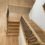 Natural hardwood floors refinished with Bona NordicSeal and Bona Traffic HD, with updated staircase iron oval spindles in a Glenview home 