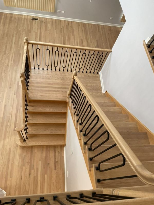 Natural hardwood floors refinished with Bona NordicSeal and Bona Traffic HD, with updated staircase iron oval spindles in a Glenview home 