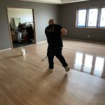 FLOORecki technician applying a finish coat during hardwood floor refinishing in a Chicago home Lincoln Park