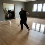 FLOORecki technician applying a finish coat during hardwood floor refinishing in a Chicago home Lincoln Park