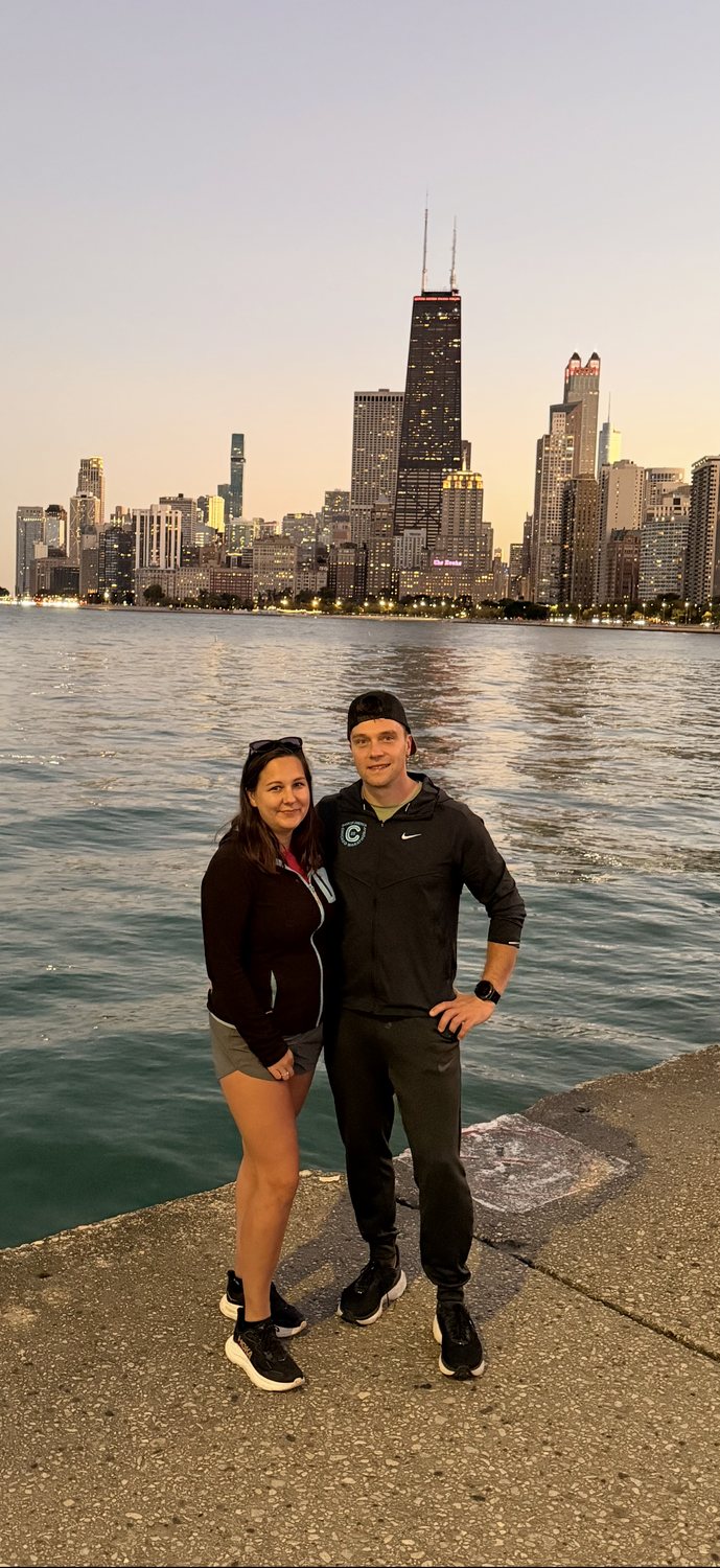 Krzysztof 'Chris' and Anna, owners of FLOORecki Floors & Stairs, in front of the Chicago skyline
